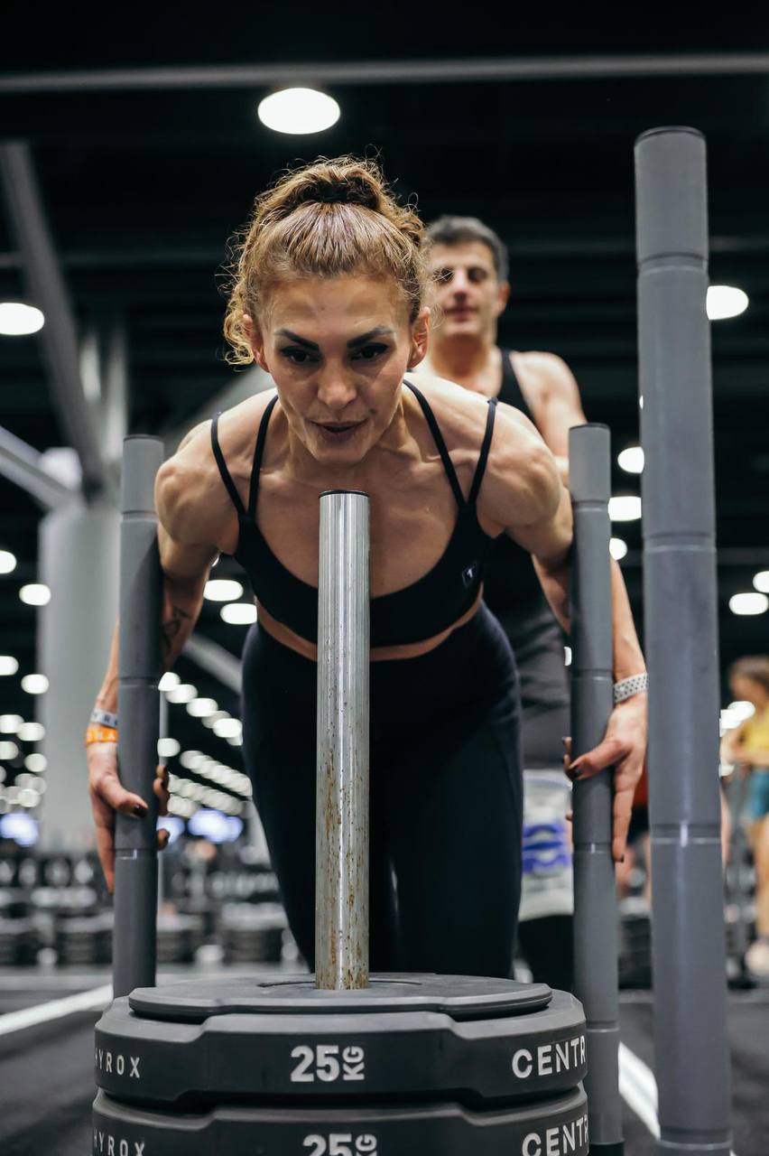 Fit4Life athlete grinding through a HYROX sled push